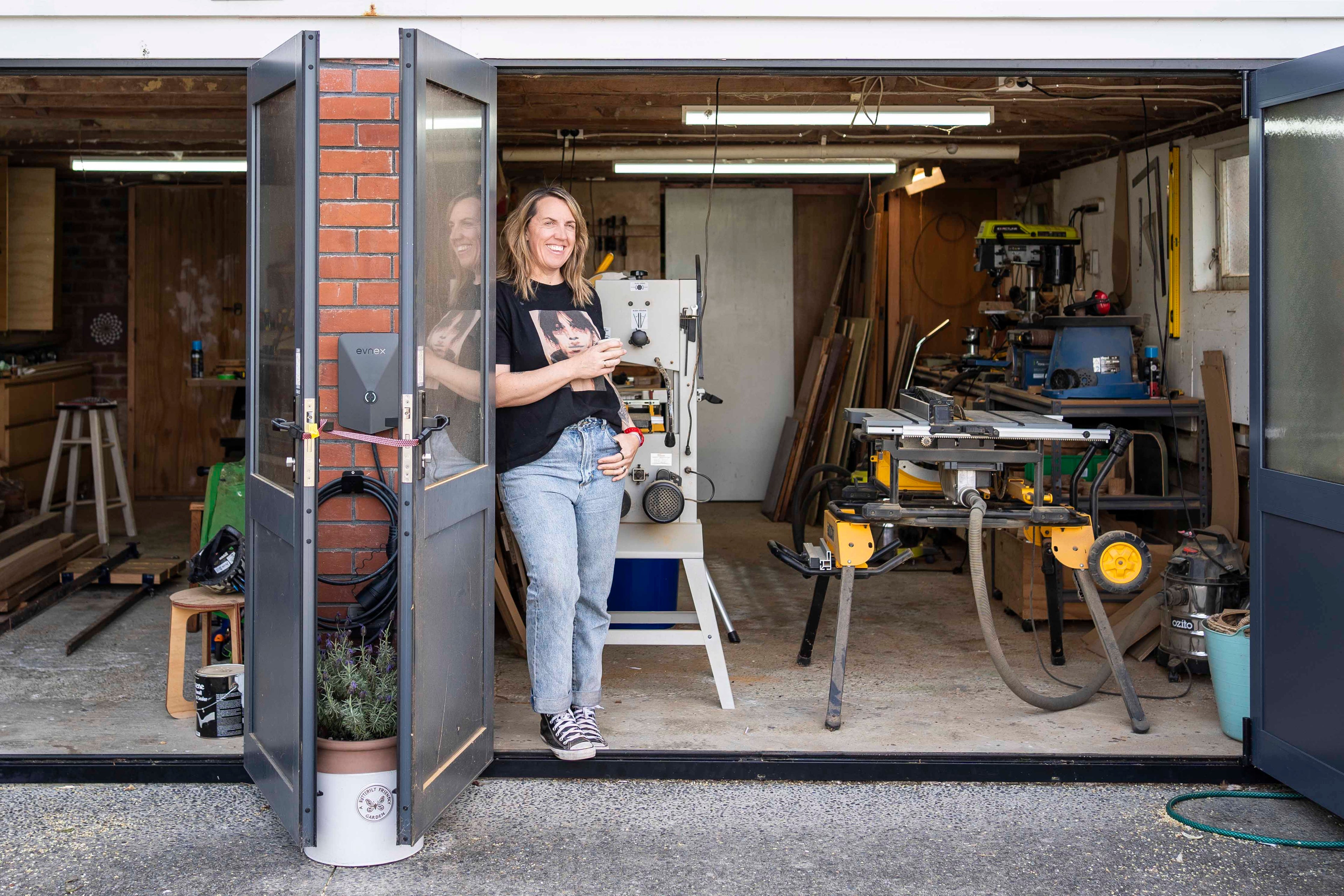 Jo Bidwell (NiceJo) standing outside her woodworking studio